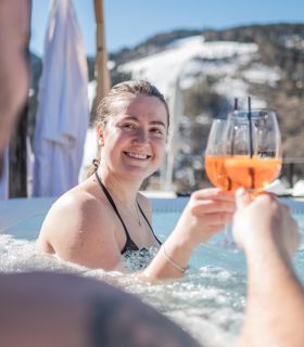 A couple is enjoying an aperitif in the outdoor whirlpool